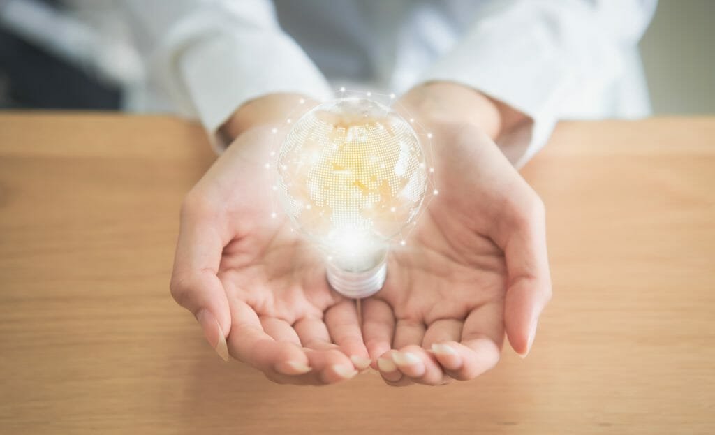 Businesswoman holding light bulb with innovative and creativity are keys to success. Concept knowledge leads to ideas and inspiration.