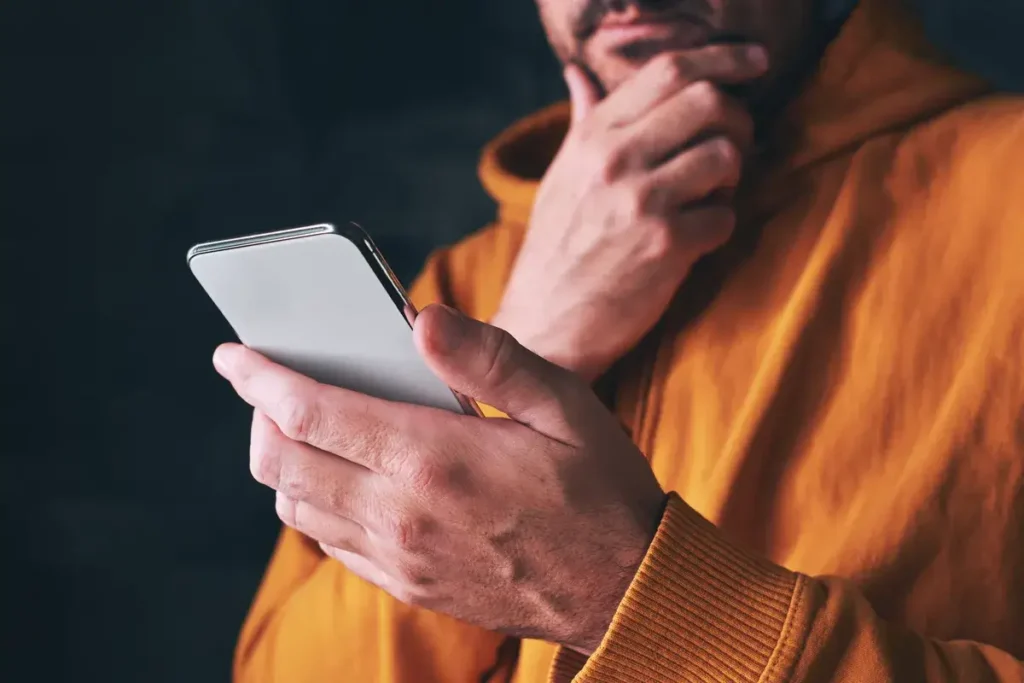 man-using-smartphone-reading-online