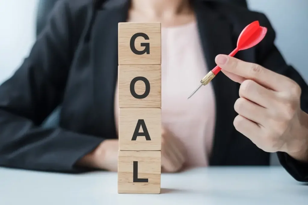 hand-holding-red-dart-over-goal-block-target