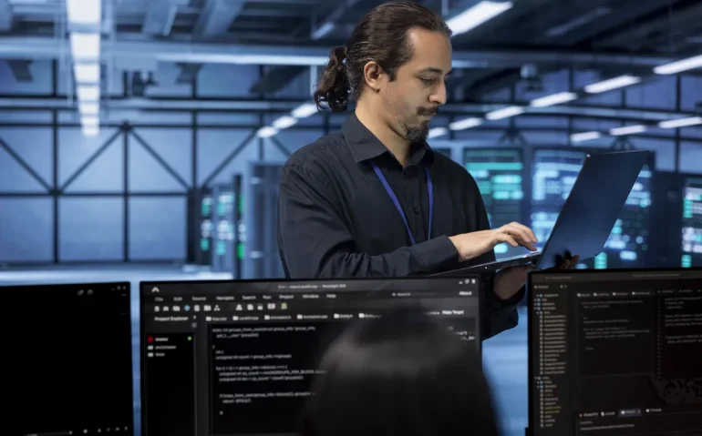 engineer-standing-in-data-center-typing