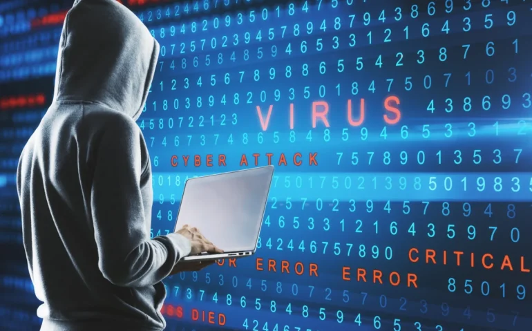 hacker-typing-on-laptop-against
