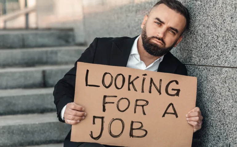 jobless-man-holding-sign-on-concrete
