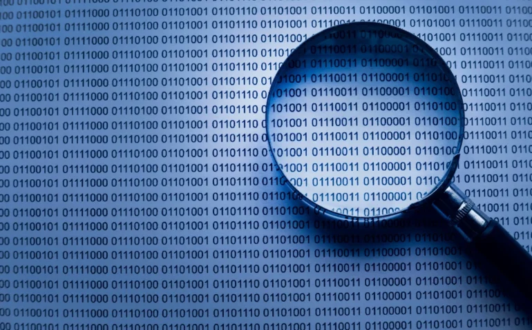 magnifying-glass-inspecting-binary-code-informatio