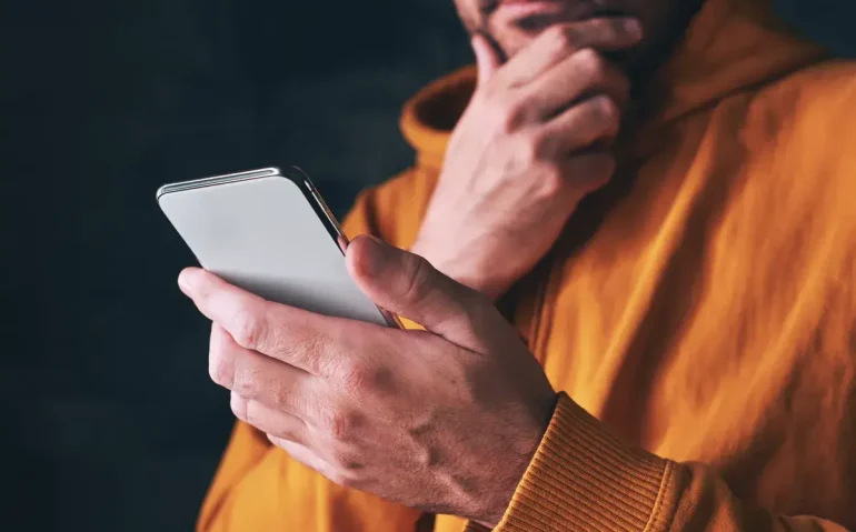 man-using-smartphone-reading-online