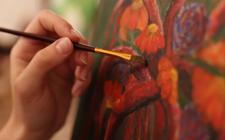 painting-flowers-with-a-brush-on-canvas